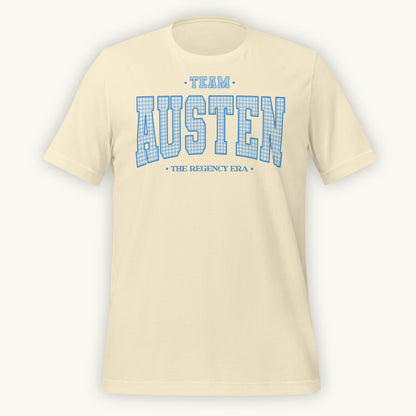 Cream colored t-shirt with 'Team Austen The Regency Era' in blue gingham style varsity text on a white background