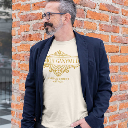 Man wearing a vintage white color P.G. Wodehouse t-shirt with gold Jeeves text against a brick wall